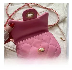 Close-up of pink quilted mini bag showing flap design and golden twist-lock closure