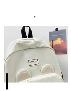 Detail of cream kids backpack featuring cute 3D animal ears and Happy Day patch