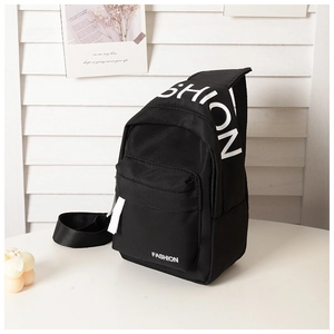 Detail of black canvas chest bag for kids featuring white FASHION lettering and zip pockets