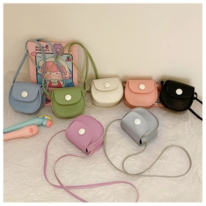 Detailed view of kids mini crossbody bags in seven vibrant colors and matte PU leather