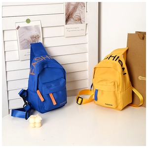 Close-up of lightweight nylon kids chest bags with fashion letter print in yellow and blue
