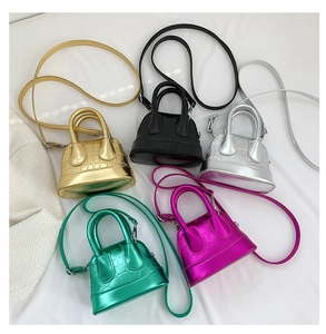 Close-up of mini shell bags in five metallic colors featuring crocodile pattern texture