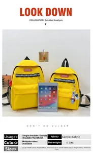 Detail view of yellow canvas backpacks in two sizes with astronaut charms and reflective strips