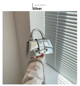 Detail of silver mini trapezoid handbag with glossy mirror finish and beaded metal chain