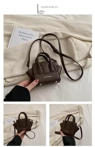 Dettaglio mini borsa a tracolla marrone caffè con doppi manici e piedini in metallo