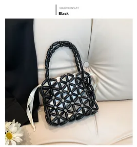 Detailed close-up of a black beaded handbag for girls with white drawstring inner pouch