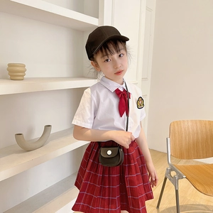 Kids academic style outfit with white shirt, red plaid pleated skirt and mini crossbody bag