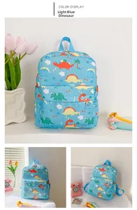 Detail view of light blue children's backpack featuring colorful cartoon dinosaur prints