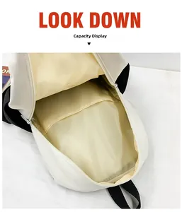 Interior view showing the large capacity and inner pockets of children's canvas backpack