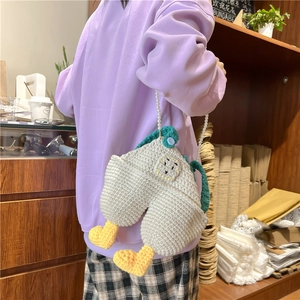 Handmade crochet cartoon duck crossbody bag with pearl strap and green overalls design