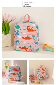 Detail view of pink kids backpack with colorful dinosaur prints and front zipper pocket