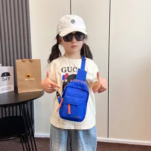 Kids bright blue canvas crossbody chest bag with adjustable strap and orange zipper detail
