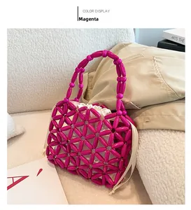 Detail of rose red beaded handbag with floral weave pattern and white drawstring pouch