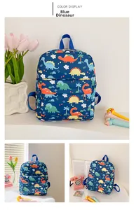 Detail of blue kids backpack with colorful dinosaur prints and front zipper pocket