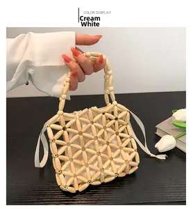 Detail of hand-woven cream wooden bead bag with floral pattern and drawstring lining