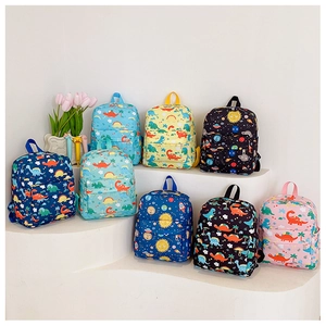 Close-up of various cartoon dinosaur backpacks for kids in diverse colorful designs