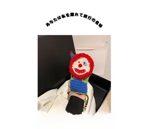 Detail of handmade crochet clown crossbody bag with colorful knitted wool texture