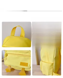 Detail view of the yellow duck backpack showing zipper pocket, 3D beak, and side mesh compartment