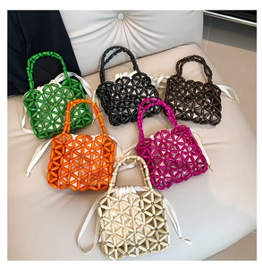 Detail of colorful beaded woven handbags featuring various colors and drawstring inner bags