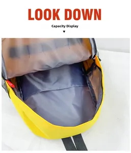 Detailed interior view of yellow canvas kids backpack showing large capacity and grey lining