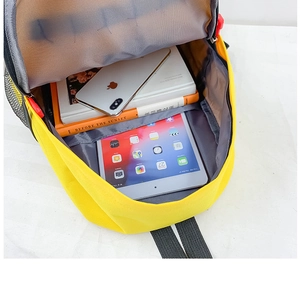 Internal view of a yellow canvas backpack showing spacious main compartment and laptop sleeve