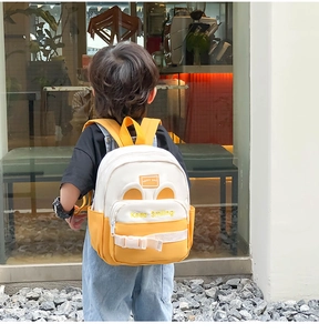 Detail of yellow canvas kids backpack with cute animal ears and Keep Smiling embroidery