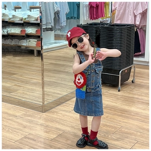 Kids clown crochet crossbody bag styled with denim overall dress and red letter cap