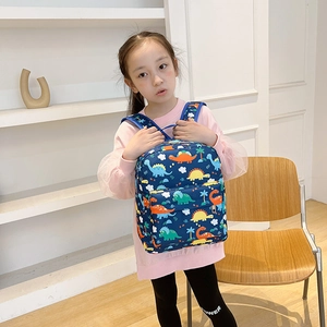 Navy blue children's dinosaur backpack with colorful cartoon prints on school girl