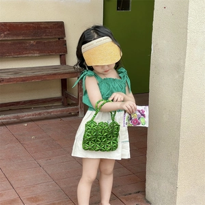 Handmade green beaded handbag for girls featuring a stylish woven mesh texture and round handle