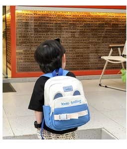 Detail of blue canvas kids backpack with Keep Smiling embroidery and cute 3D ears