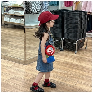 Kids clown-themed hand-knitted crossbody bag paired with vintage denim overall dress
