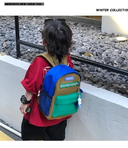 Close-up of kids' color-block canvas backpack with reflective strip and side mesh pocket
