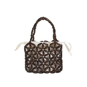 Handmade woven wooden bead handbag for girls featuring a white drawstring inner pouch