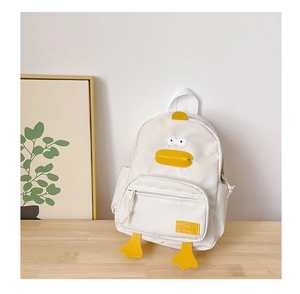 Detailed close-up of a cartoon duck canvas backpack with a front zipper pocket on a wooden table