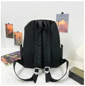 Detail view of ergonomic padded shoulder straps and side pocket on this canvas backpack