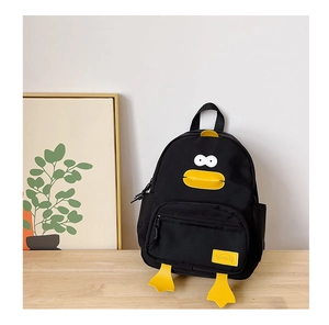 Close-up of black duck backpack with 3D yellow beak and durable canvas texture