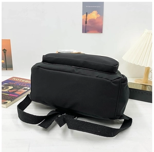 Detailed bottom view of black canvas school backpack with reinforced straps for durability