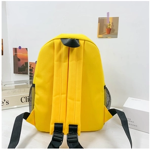Detail of yellow canvas backpack showing adjustable padded straps and side mesh pockets