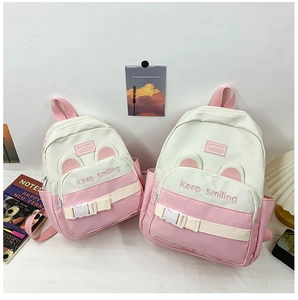 Detail of pink canvas backpacks in two sizes with cute rabbit ears and buckles