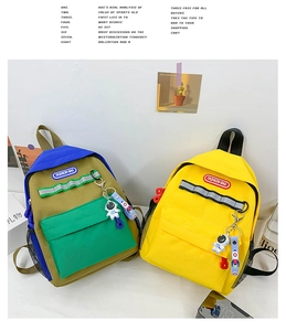 Detail view of colorful children canvas backpacks with astronaut charms and mesh side pockets