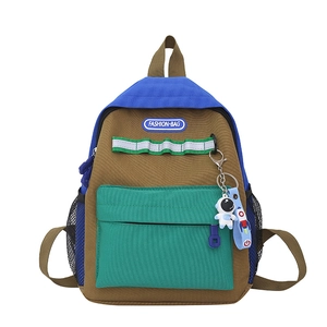 Kids color-block canvas backpack with astronaut charm and fashion-bag label in blue and brown