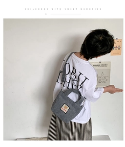 Detailed back view of a child wearing a grey corduroy teddy bear crossbody bag