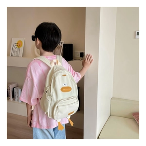 Detail view of the durable canvas material and cute cartoon duck design on kids backpack