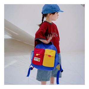 Detail view of colorful contrast canvas kids backpack showing mesh pocket and bear patch