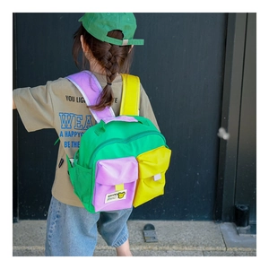 Outdoor shot of the colorful kids backpack with adjustable straps and bear label
