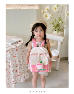 Detail of color-block canvas backpack for girls with cute cartoon pendant and side mesh pocket