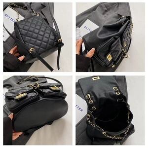 Detail view of black quilted faux leather backpack with gold chain straps and twist-lock
