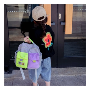 Detail of kids canvas backpack showing grey purple contrast and dual square pockets
