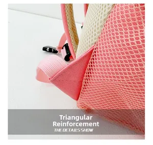 Detail view of pink canvas backpack featuring reinforced triangle stitching on mesh straps