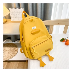 Close-up of yellow cartoon duck backpack with 3D beak and fabric shoulder straps
